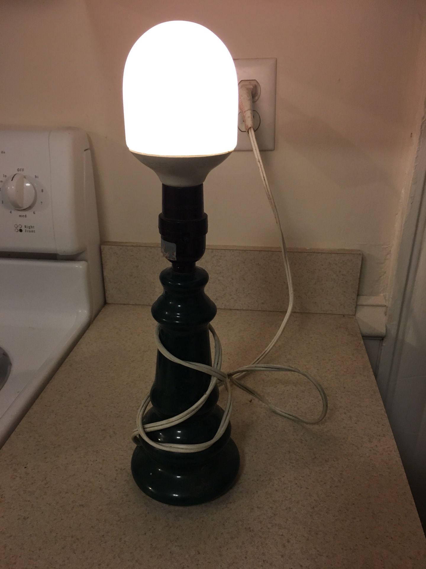 Small dark green desk lamp with compact fluorescent bulb.