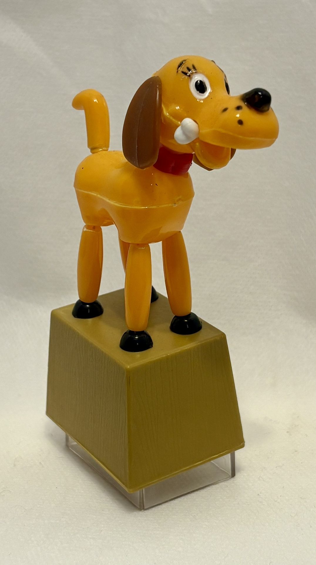 MODERN TOYS plastic dog push puppet with bone; also a pencil sharpener