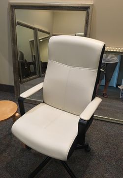 Elegant black and white executive swivel desk chair.