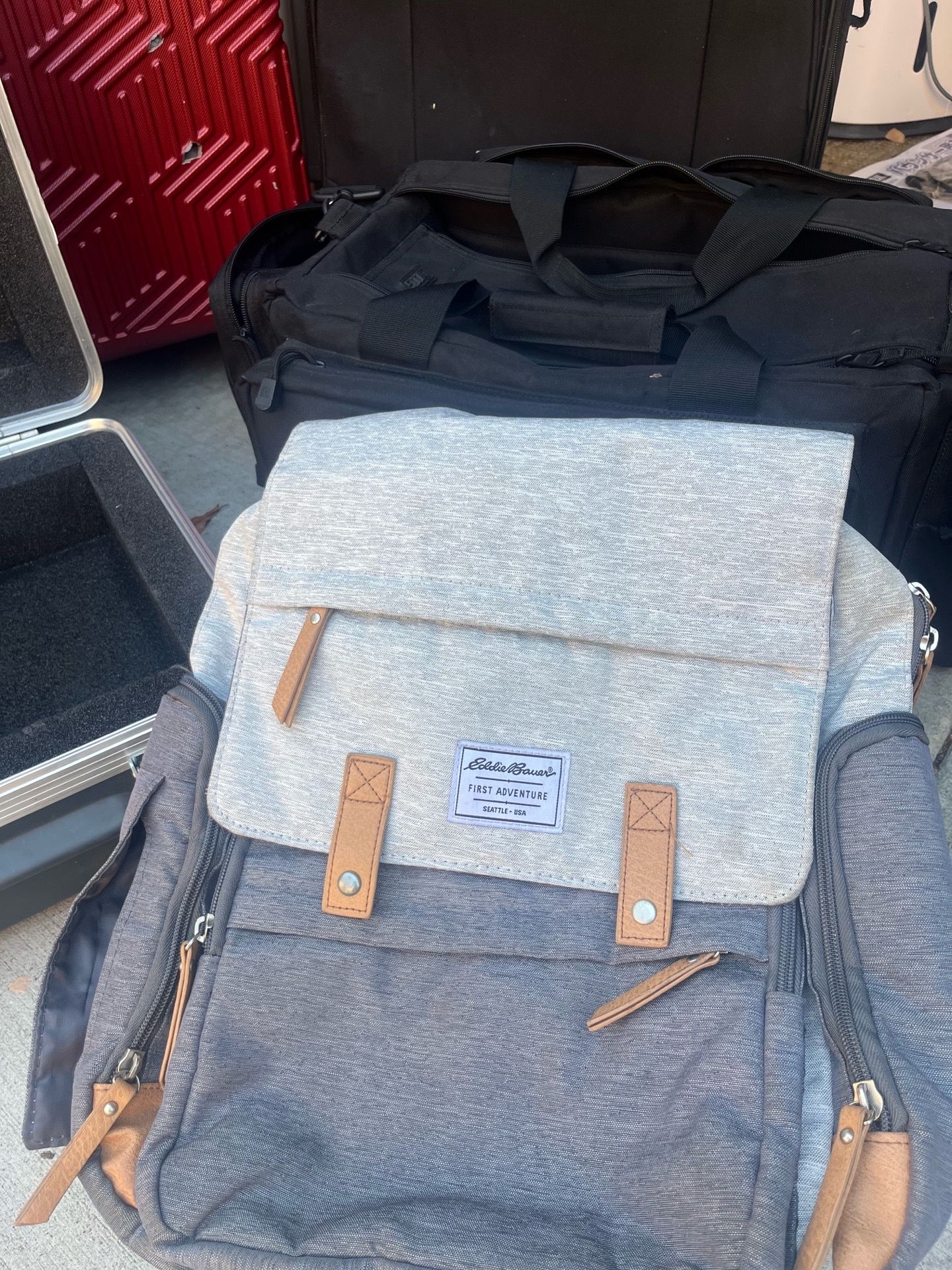 Stylish gray diaper bag backpack with multiple storage compartments.