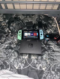 Nintendo switch with two controllers, joysticks, and a joy-sticks grip for 220
