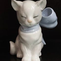 This is a Nao by Lladro "Kitty Present" porcelain figurine with a blue bow. 
