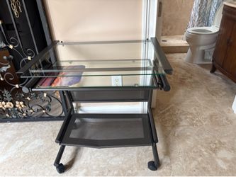 This is a Calico Designs black glass mobile cart featuring a two-shelf design with tempered safety glass.