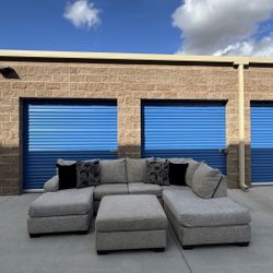 Living Spaces Grey Sectional Couch With Ottoman