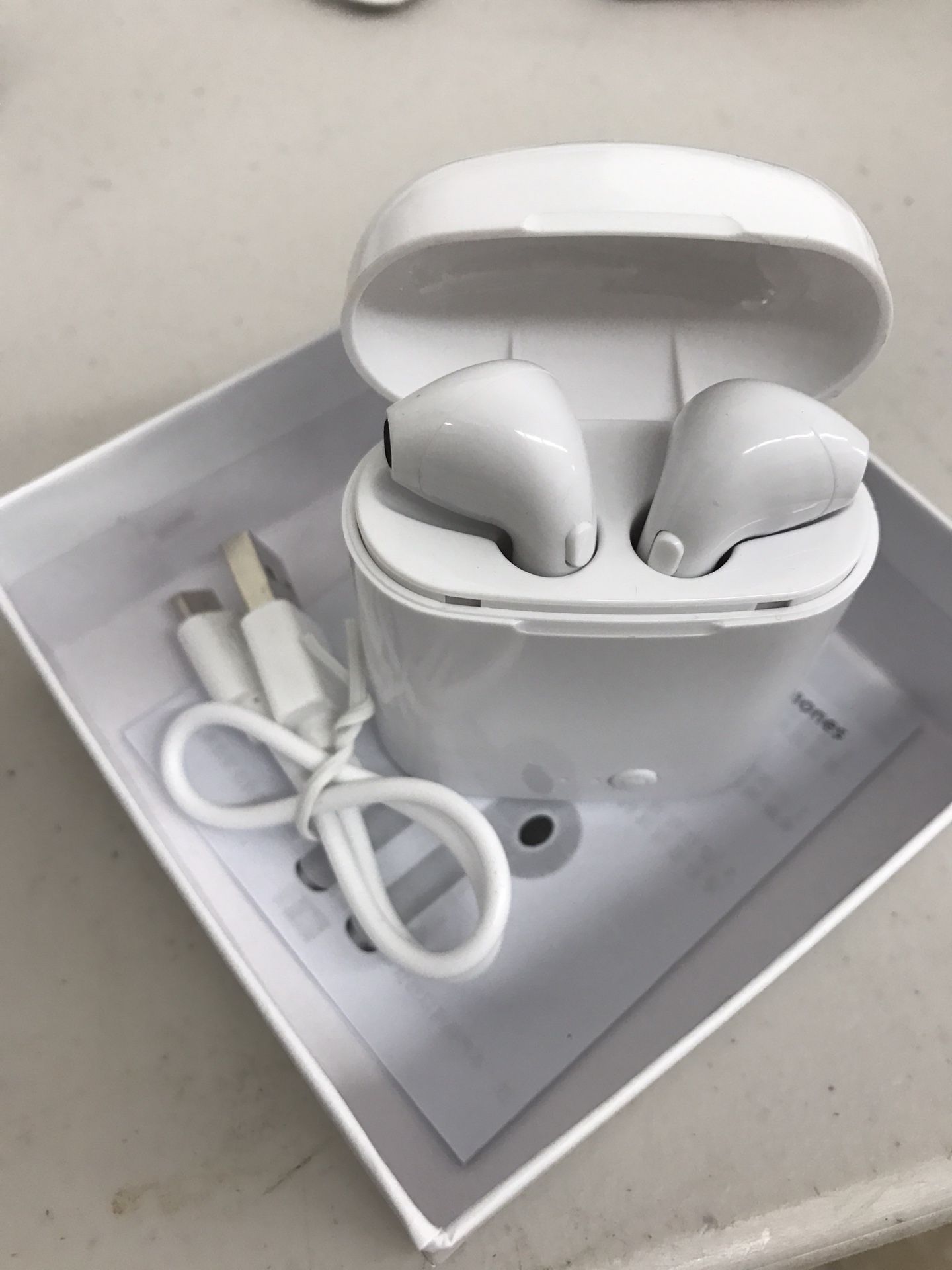 Wireless ear headset with charging station