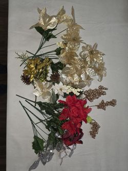 Assorted artificial flowers in gold, red, and white