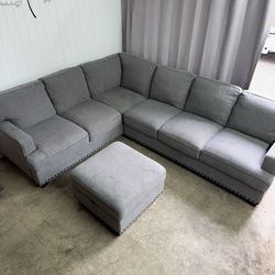 Large gray sectional couch with ottoman