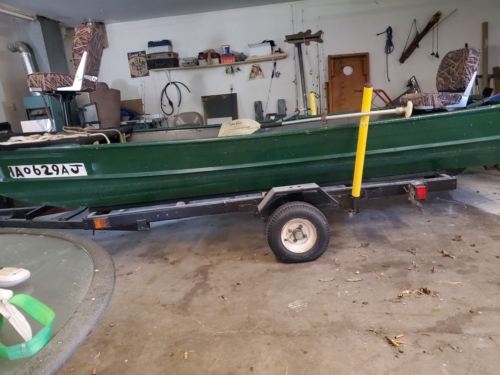 Green 14 foot  jon Boat. 15 HP Honda  Lots of extras