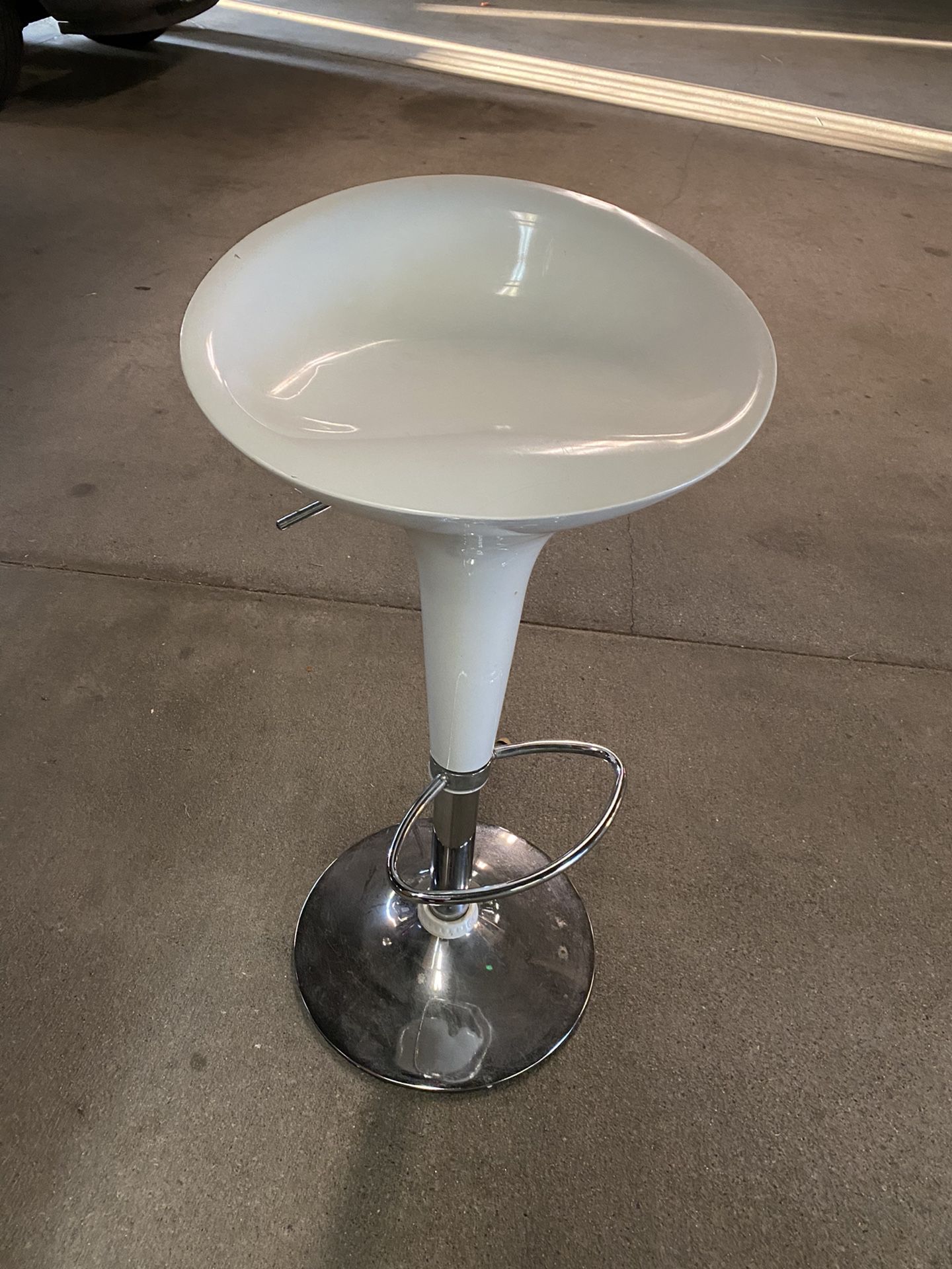 White swivel bar stool