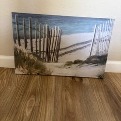 Serene beach scene canvas wall art. This piece is a gallery-wrapped canvas print featuring a coastal landscape