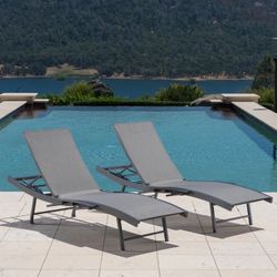 Two grey outdoor lounge chairs