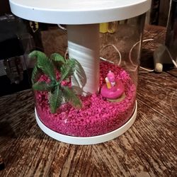 3.5 gallon topfin 360 degree fish tank with pink rocks and aquarium decorations.