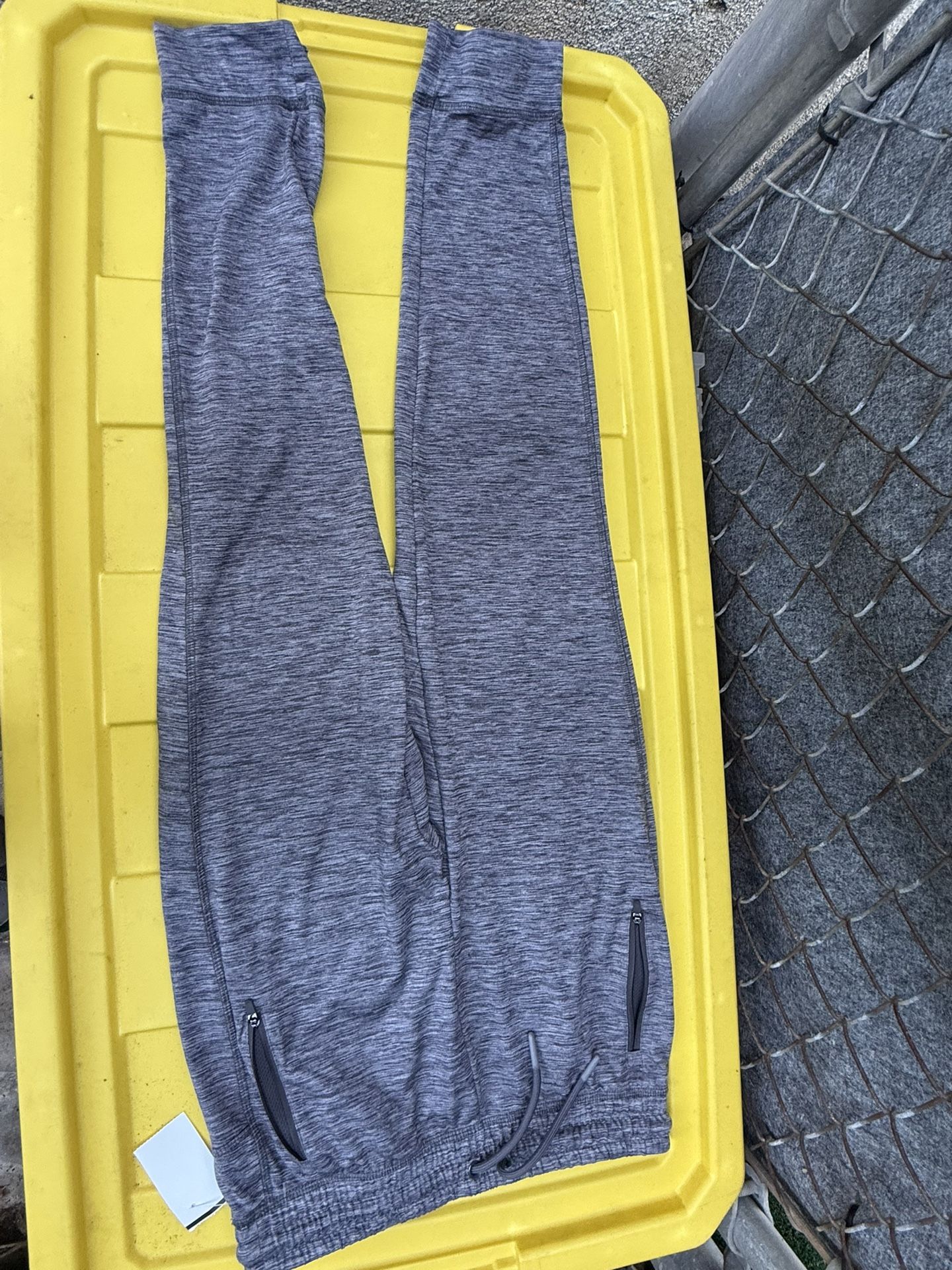 The sports pants in the image appear to be leggings or marly gray joggers,