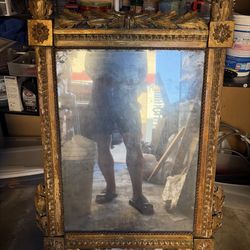 Large vintage ornate mirror with a beautifully carved gilded frame. Approximately 42 x 26 inches (107 x 66 cm). The frame features detailed laurel lea