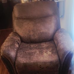 Its dark And Light Brown Color Together. Its Medium In Size And Rolls Out Into a Pretty Good Sze Recliner bed and Is pretty Comorfortable.