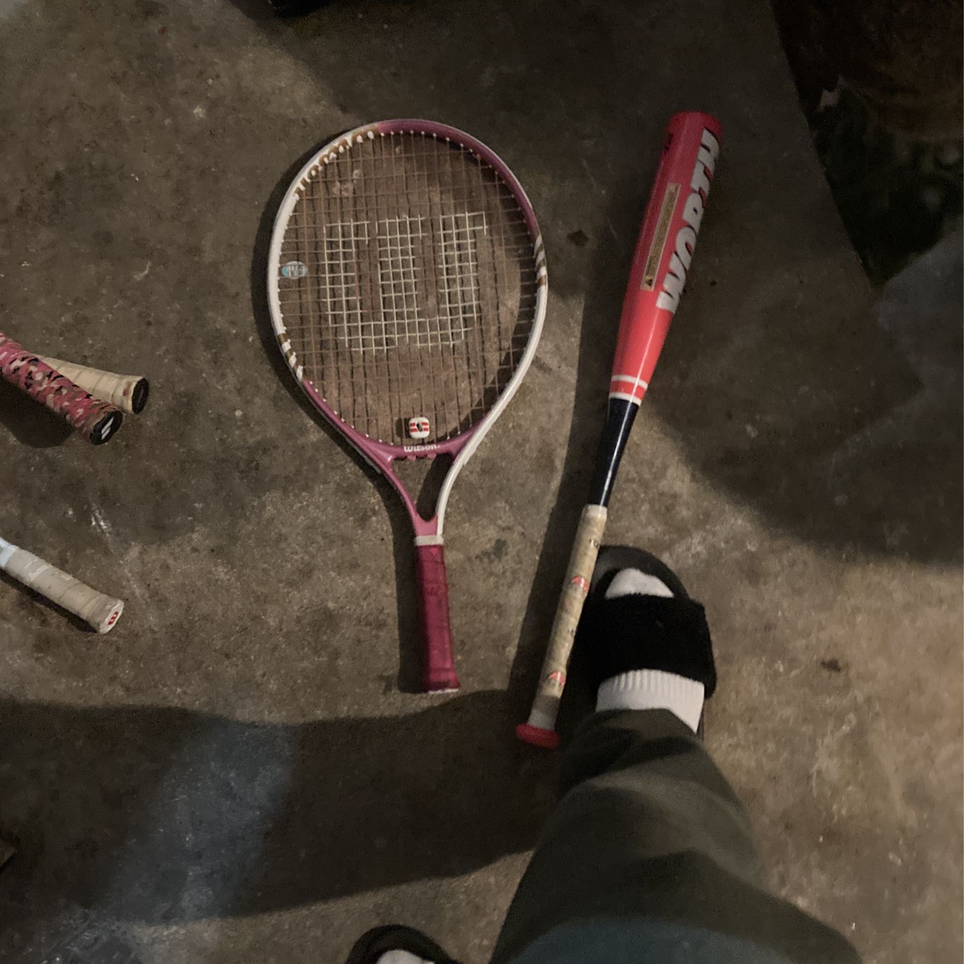 Wilson Tennis Racket And A Baseball Bat