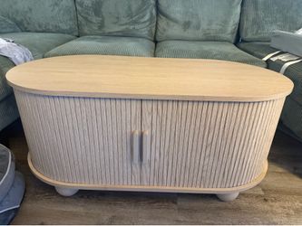 Wood coffee table with slide-able doors
