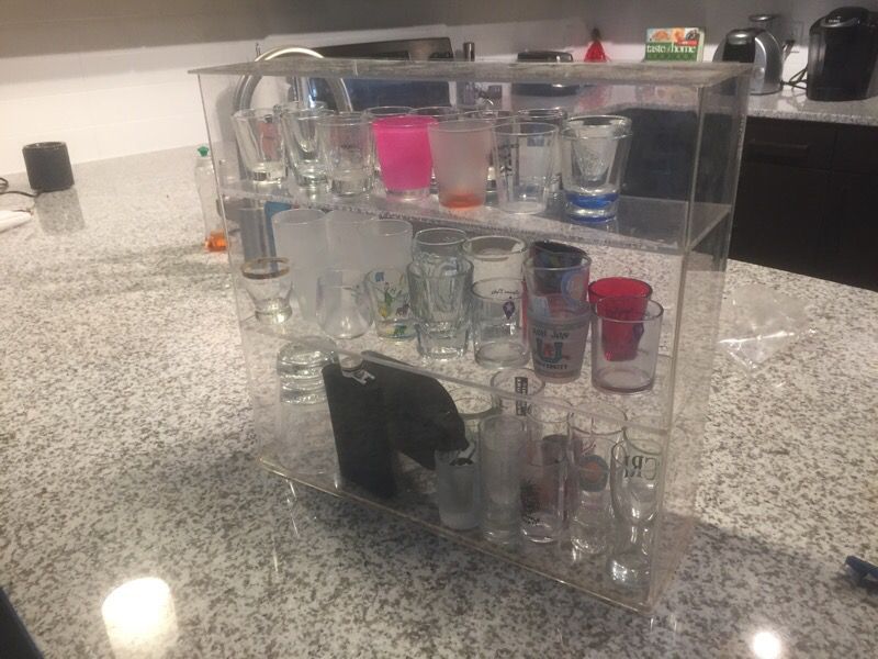 44 shot glasses, 2 flasks, 2 whiskey cups, case