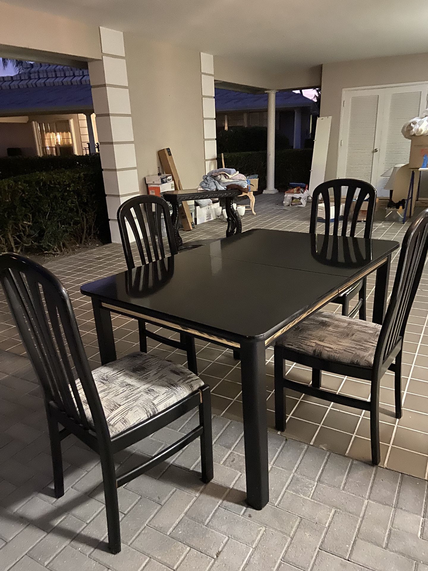 Black lacquer dining table and four chairs
