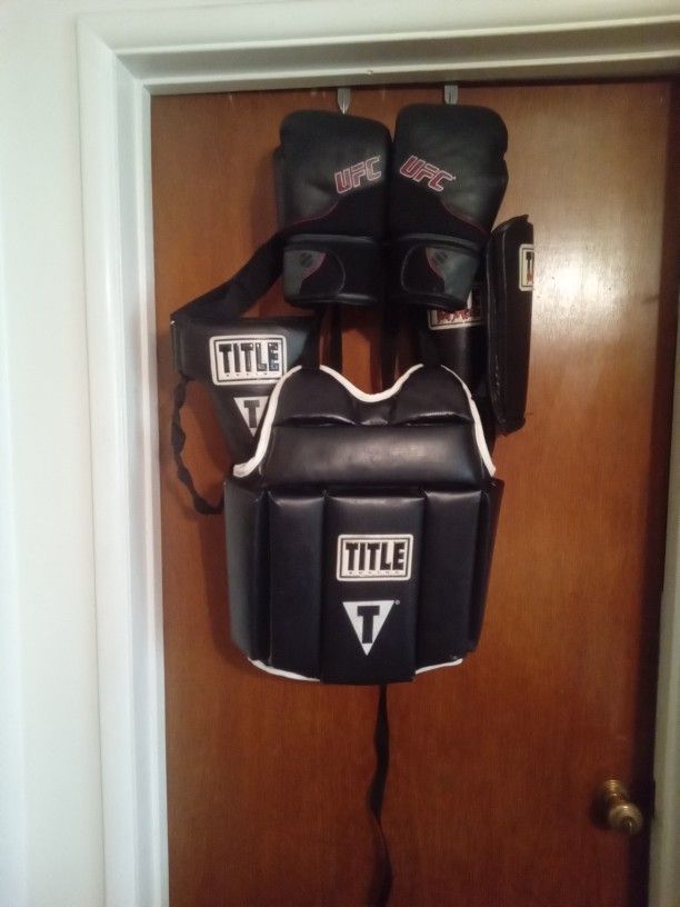 Adult Title Boxing Vest And Cup. Both Have Adjustable Straps.  Medium Shin Guards.  UFC Boxing Gloves 12 Oz. All For 