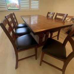 Dark brown wood, dining room table, and chair set
