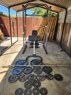 Power cage with bench/bar and weights