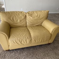 Yellow leather loveseat