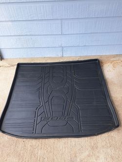 black rubber Ford Edge trunk mat with a raised lip for spill