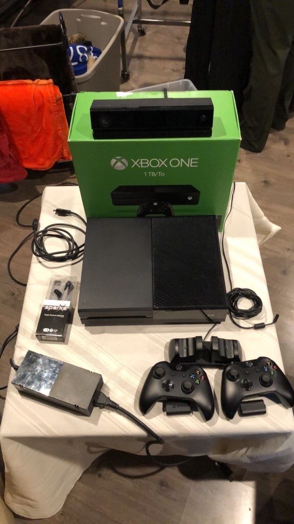 Xbox one with 2 controllers and charging station also includes earbuds with mic