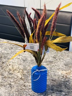 Artificial flowers with blue vase