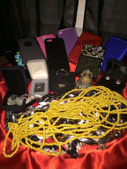Jewelery cell phone cases rings necklaces jewelry box playing that out box and card holders that are the red and blue shiny ones