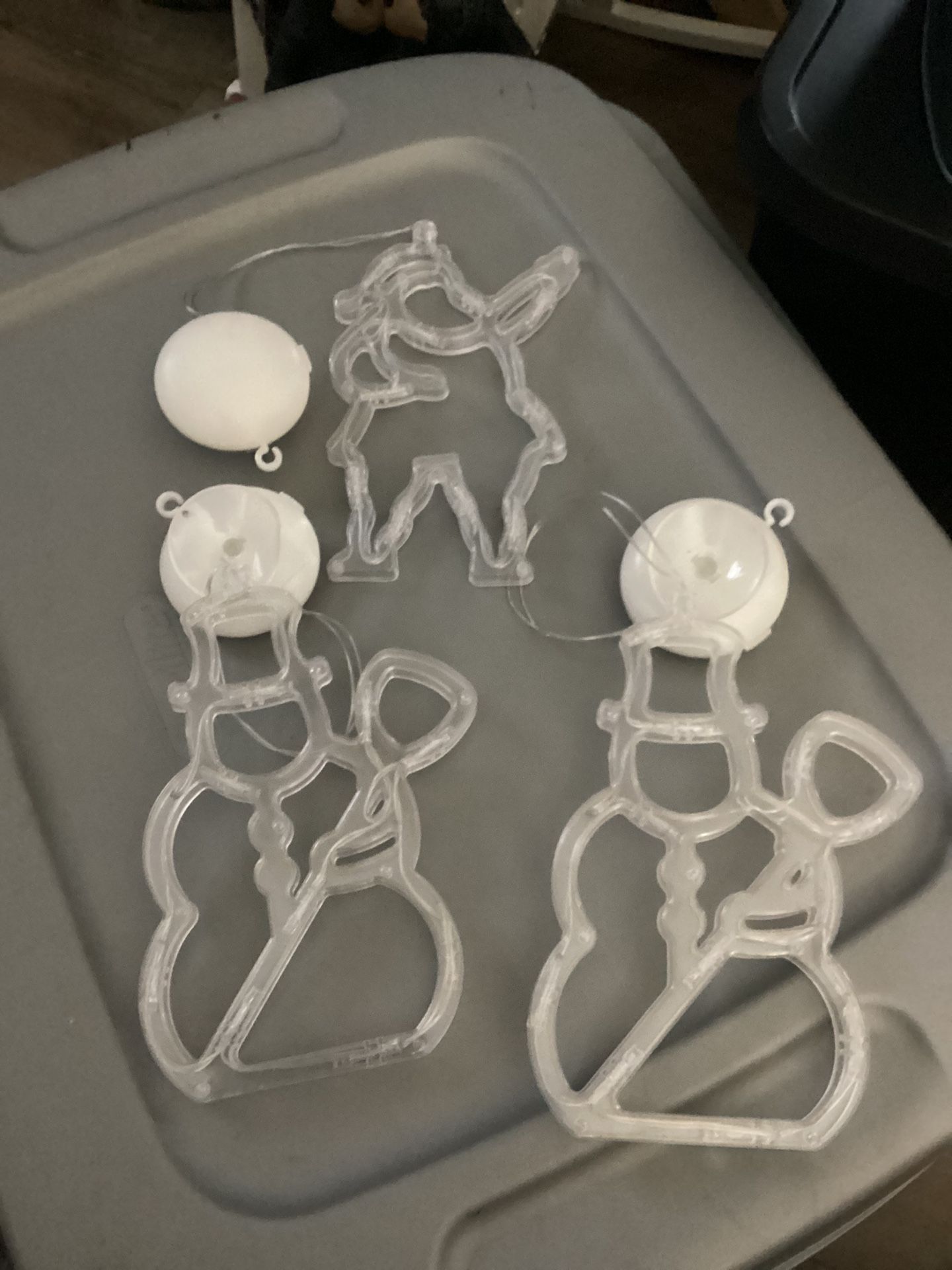 Light Up Santa And Snowmen. They take Batteries. Hang Up By A Suction Cup.