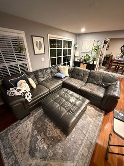 Leather sectional couch with ottoman. Approx. 110” x 103”