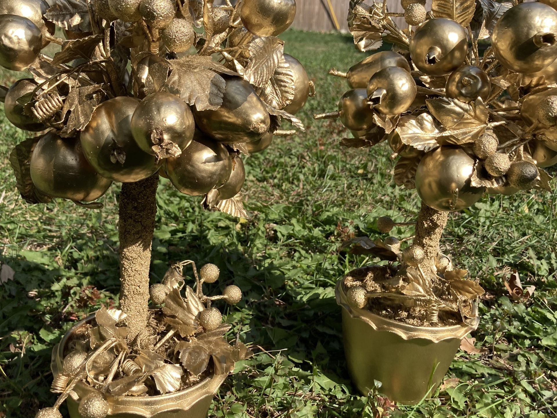 Two gold topiary fruit trees