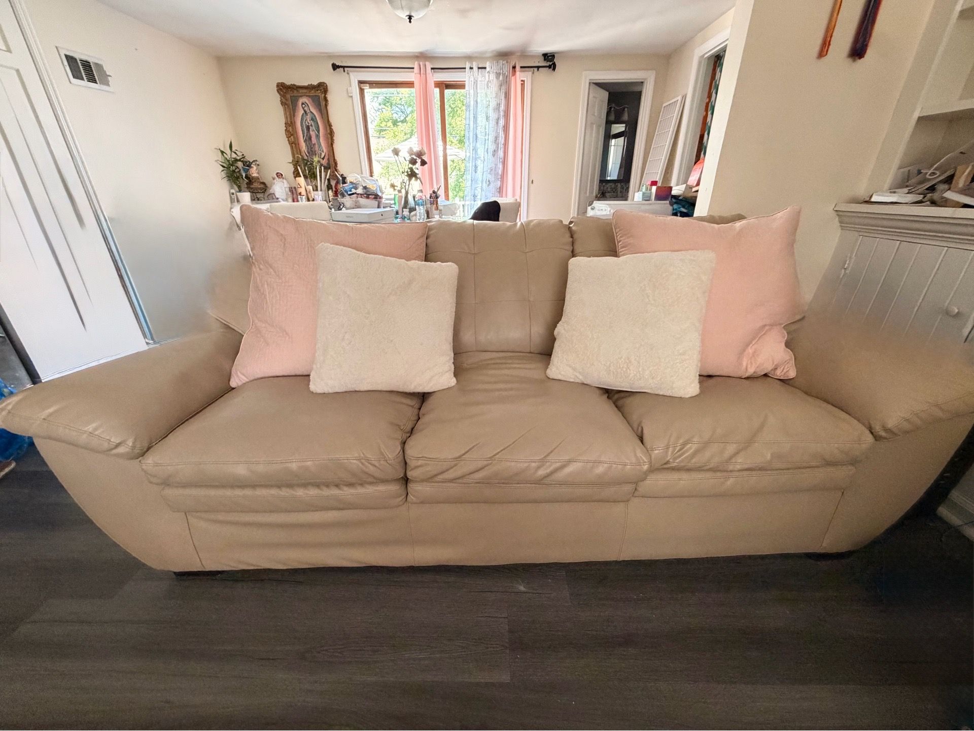 Large leather couch w/pink pillows
