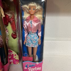 Chic Barbie doll, manufactured by Mattel in 1996.  The doll wears a blue dress with a daisy flower print and a pink jacket.  It is part of the Fashion
