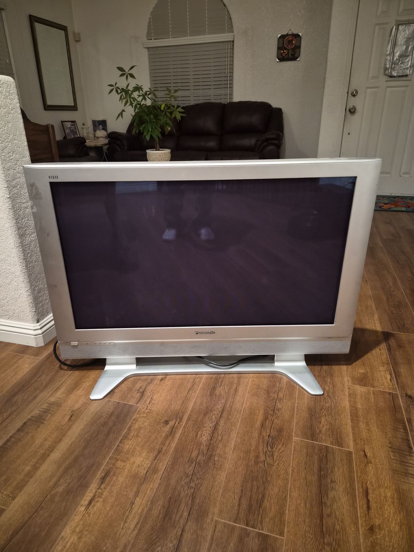 Two 42" panasonic TVs, one a plasma viera(silver), and the other a lcd(black)