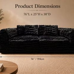 Black Plush Fur Sofa  Add a touch of modern luxury to your living space with this oversized black plush fur sofa. Featuring a soft, shaggy textu