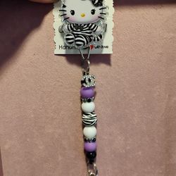 purple and black hello Kitty badge reel