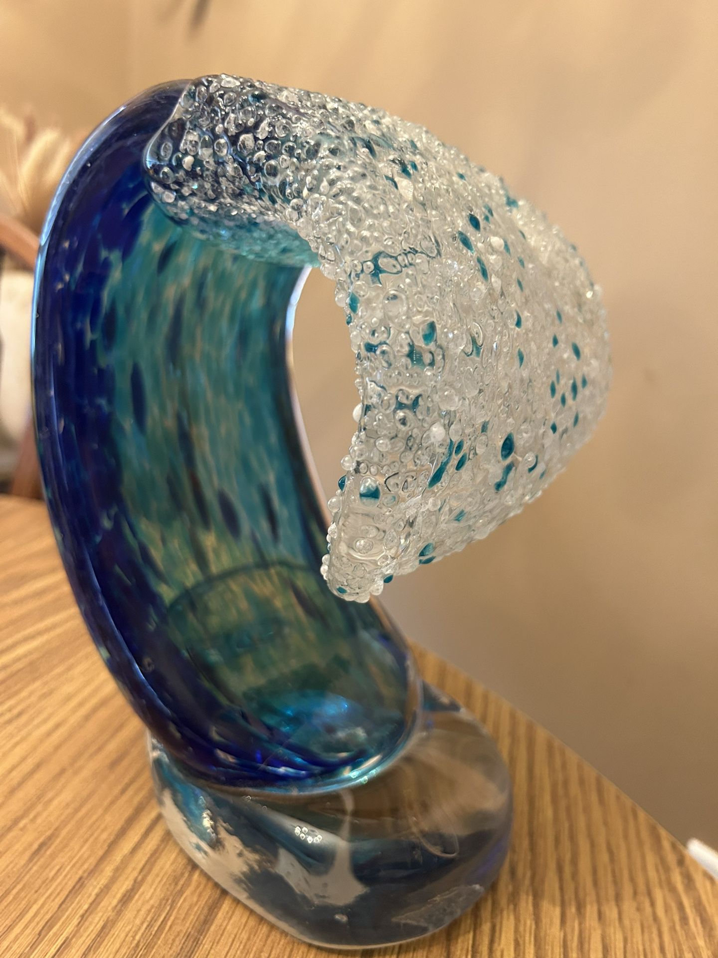 Dynasty Gallery - art glass Mega Tropic Wave 8"     This stunning figurine captures the power and beauty of an ocean wave. The tip of the wave is roll
