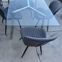glass dining table with four chairs