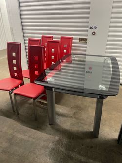 Dinning table and 6 high back chairs (see pics )