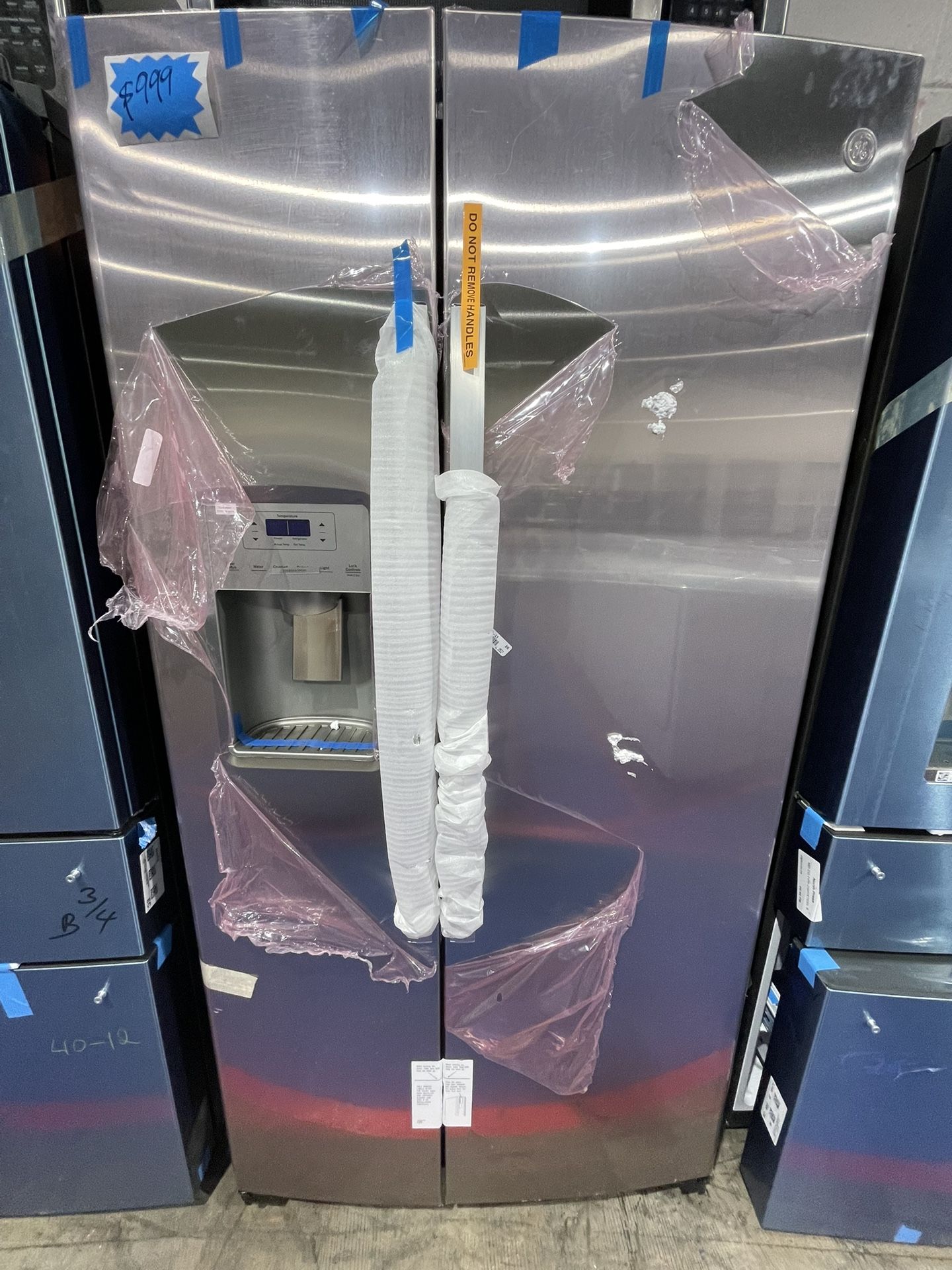 Brand new GE side-by-side stainless steel refrigerator with warranty