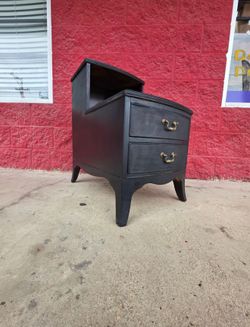Vintage telephone table, top veneer is loose on one side, has a black matte finish, very solid wood structure and bones are extremely soumd throughout
