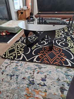 Modern Round Glass Coffee Table – Sculptural Black Petal Base