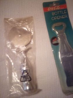 Vintage coca soda bottle opener & coca cola pizza cutter new in packing located in palm springs ca excellent