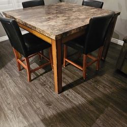 Square Marble Table With 4 one year old chairs 