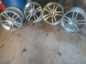 Four tire rims from a porsche