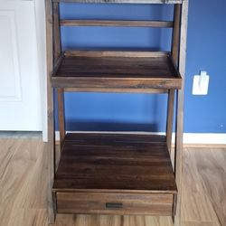 Dark wood floorshelf with a pullout drawer