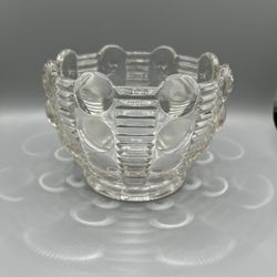 This is a clear glass candy in the Mayflower pattern also known as “Dots and Rays” by Indiana glass